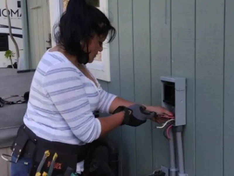 Licensed electrician wiring an exterior subpanel in Sidney